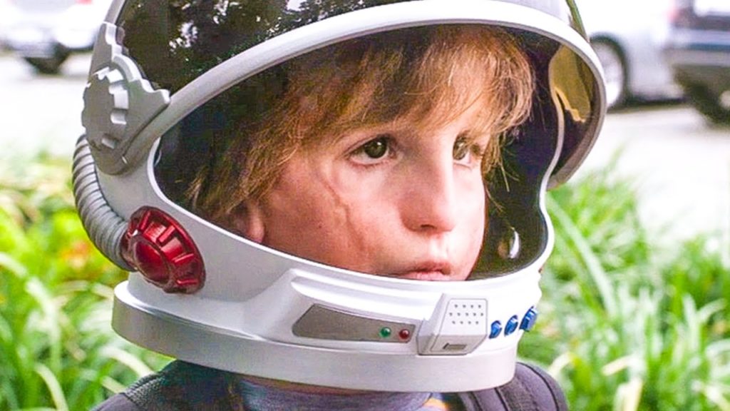 a close up of Auggie's face, he's wearing a spaceman helmet